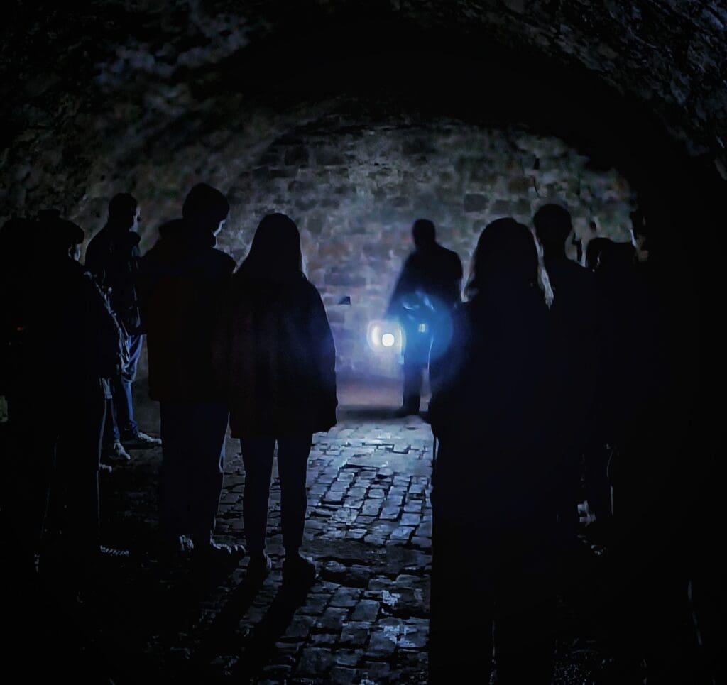 A group of tourists on the City of the Dead tour in Edinburgh